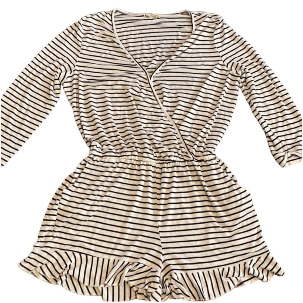 About a Girl romper. Size L. Black and white stripe. 1 closure at chest.